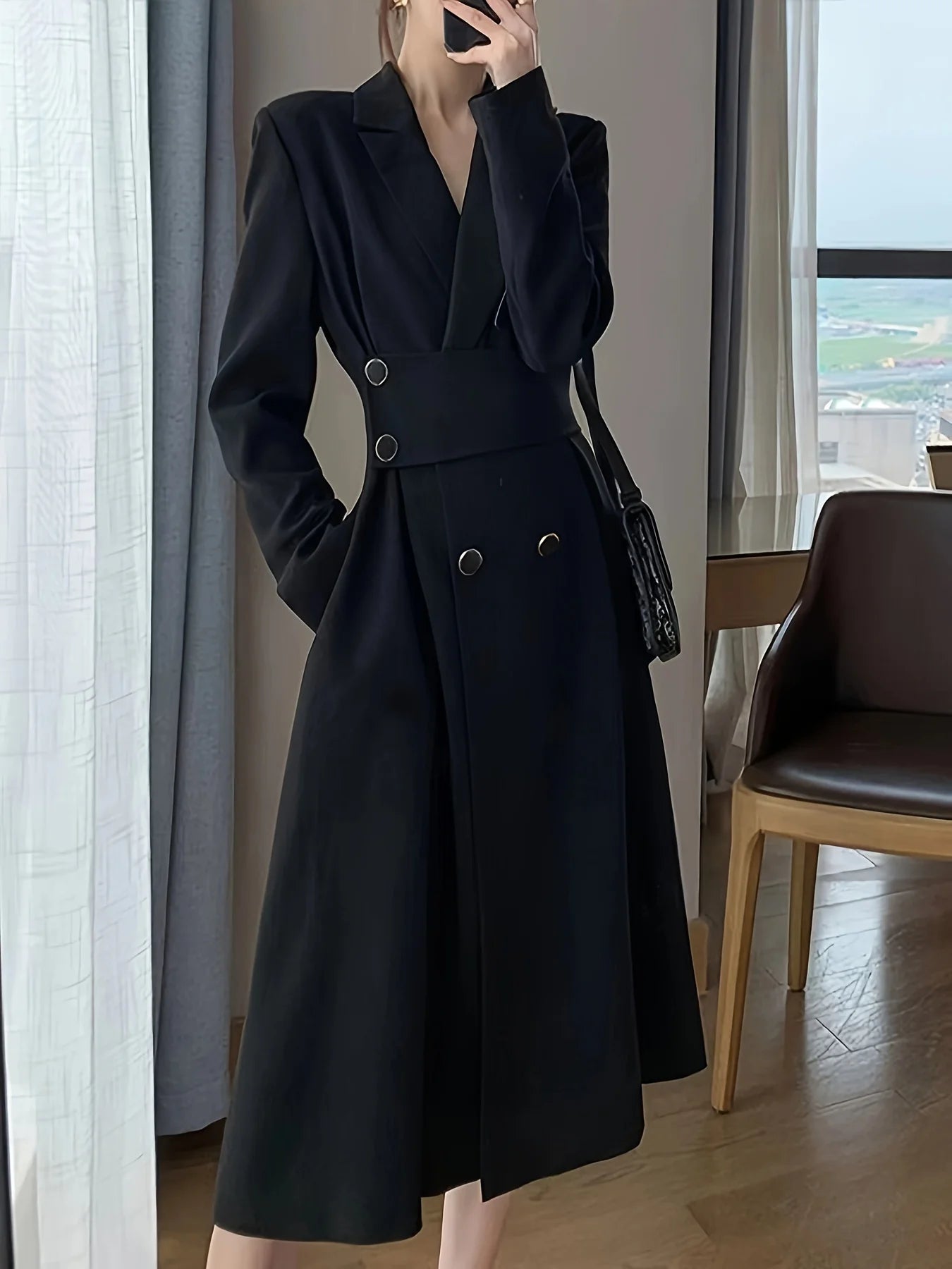 A black long-sleeved dress that is slimming and elegant, with a suit-style design.